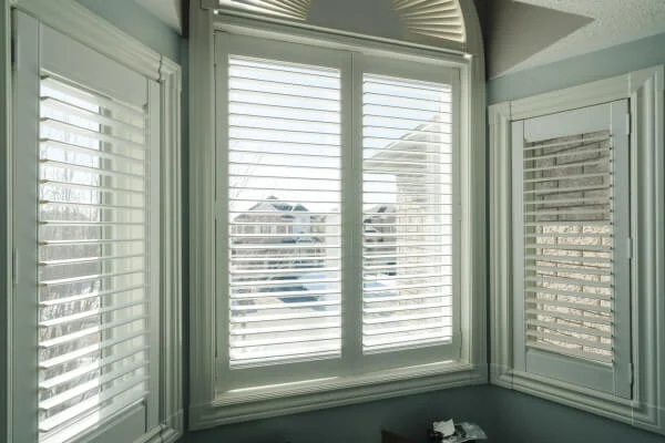 Light green bedroom with Window Plantation Shutters & Sunflares